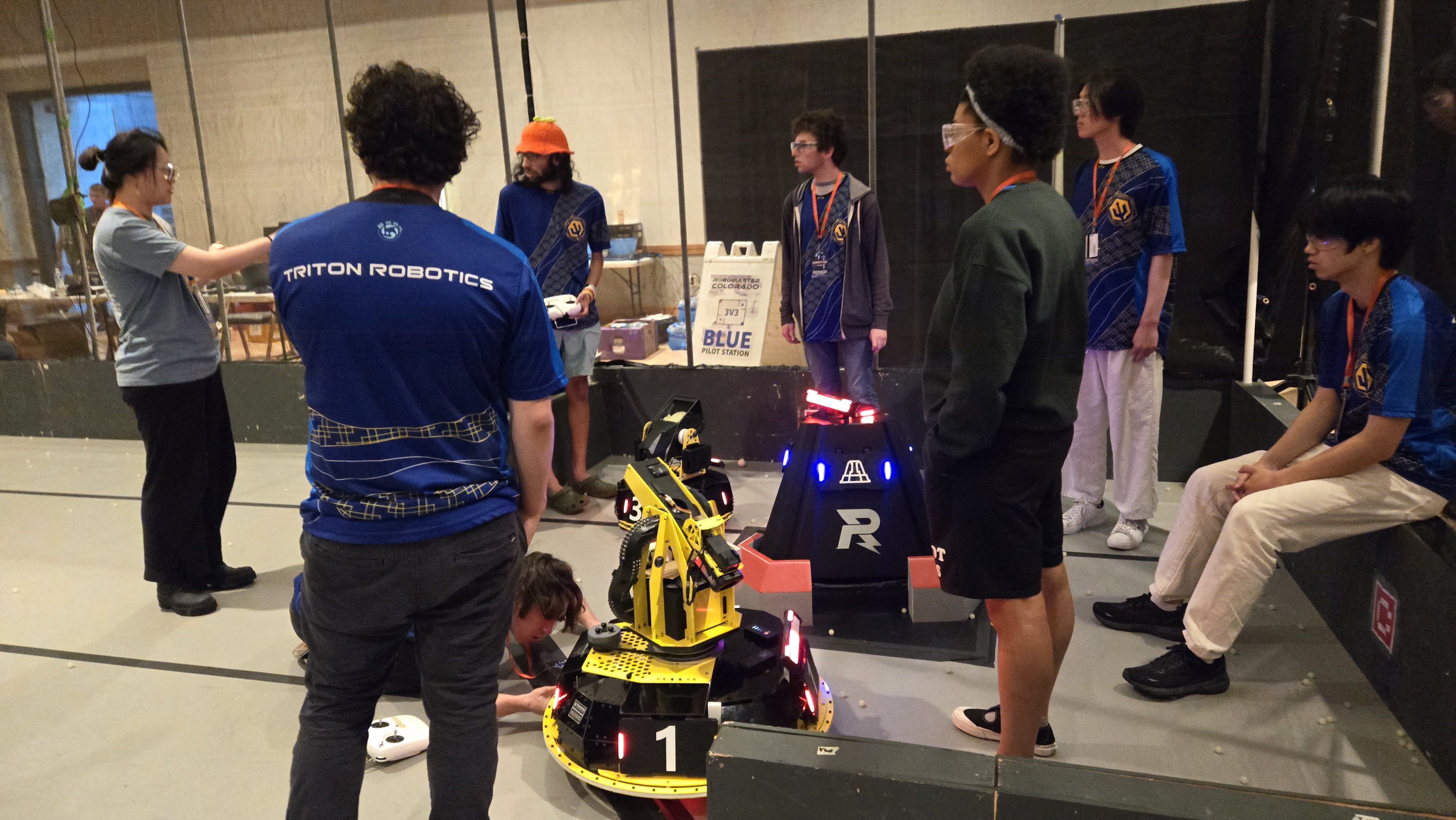 Triton Robotics members collaborating around a robot